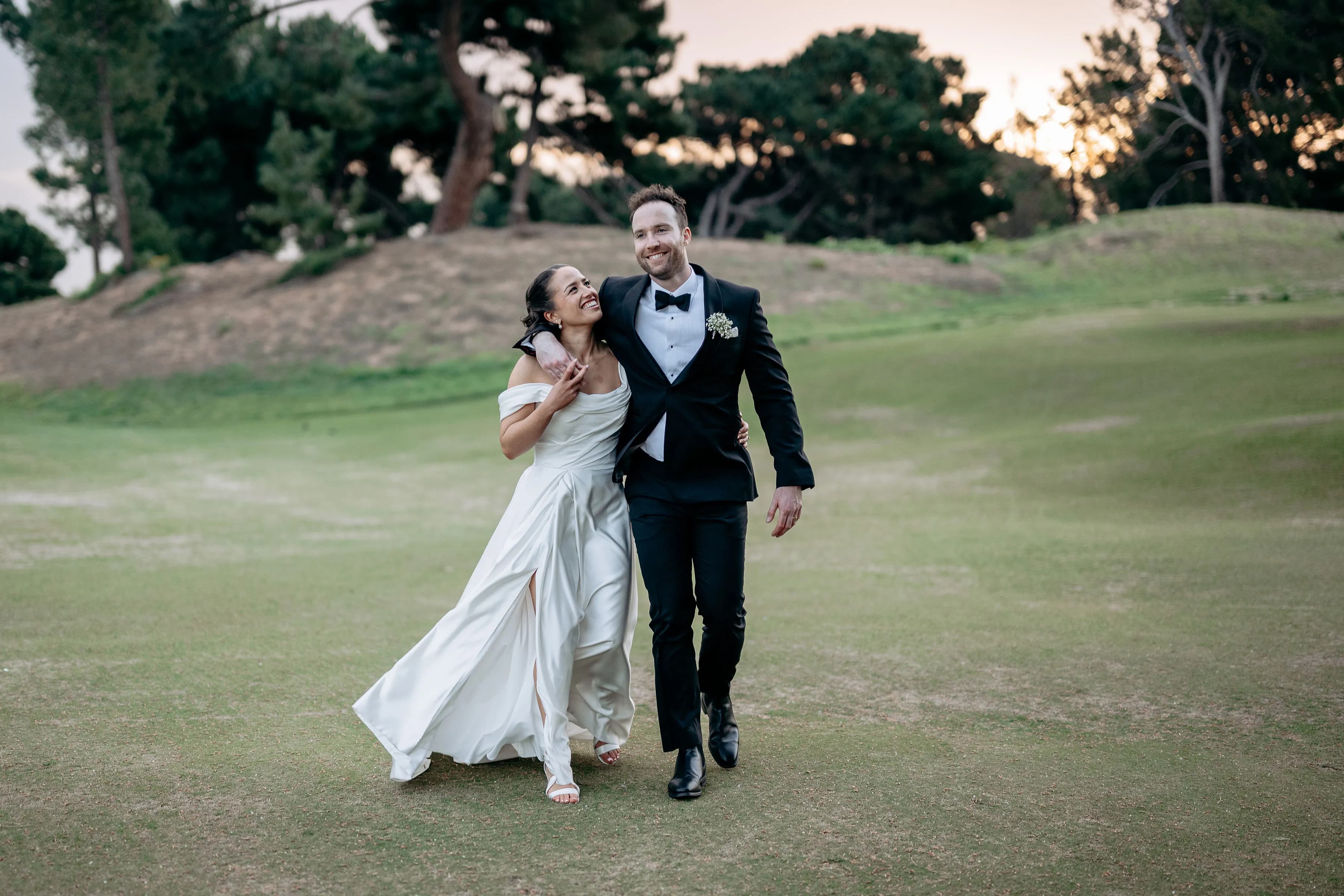 Henry and Elise walking together at sunset on their wedding day