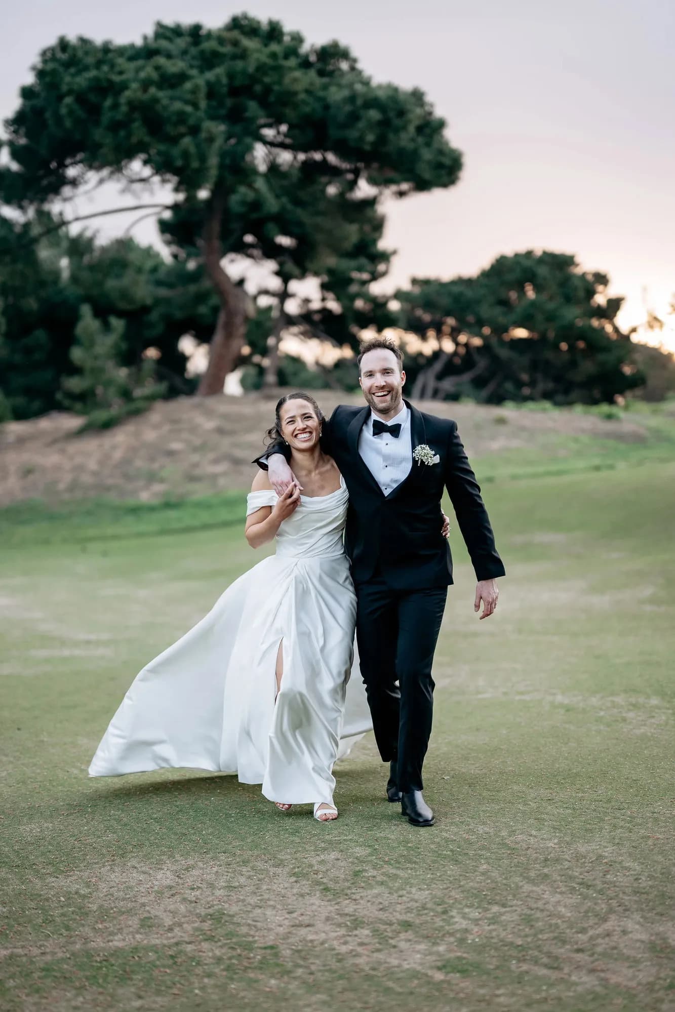 Henry and Elise walking together at sunset on their wedding day