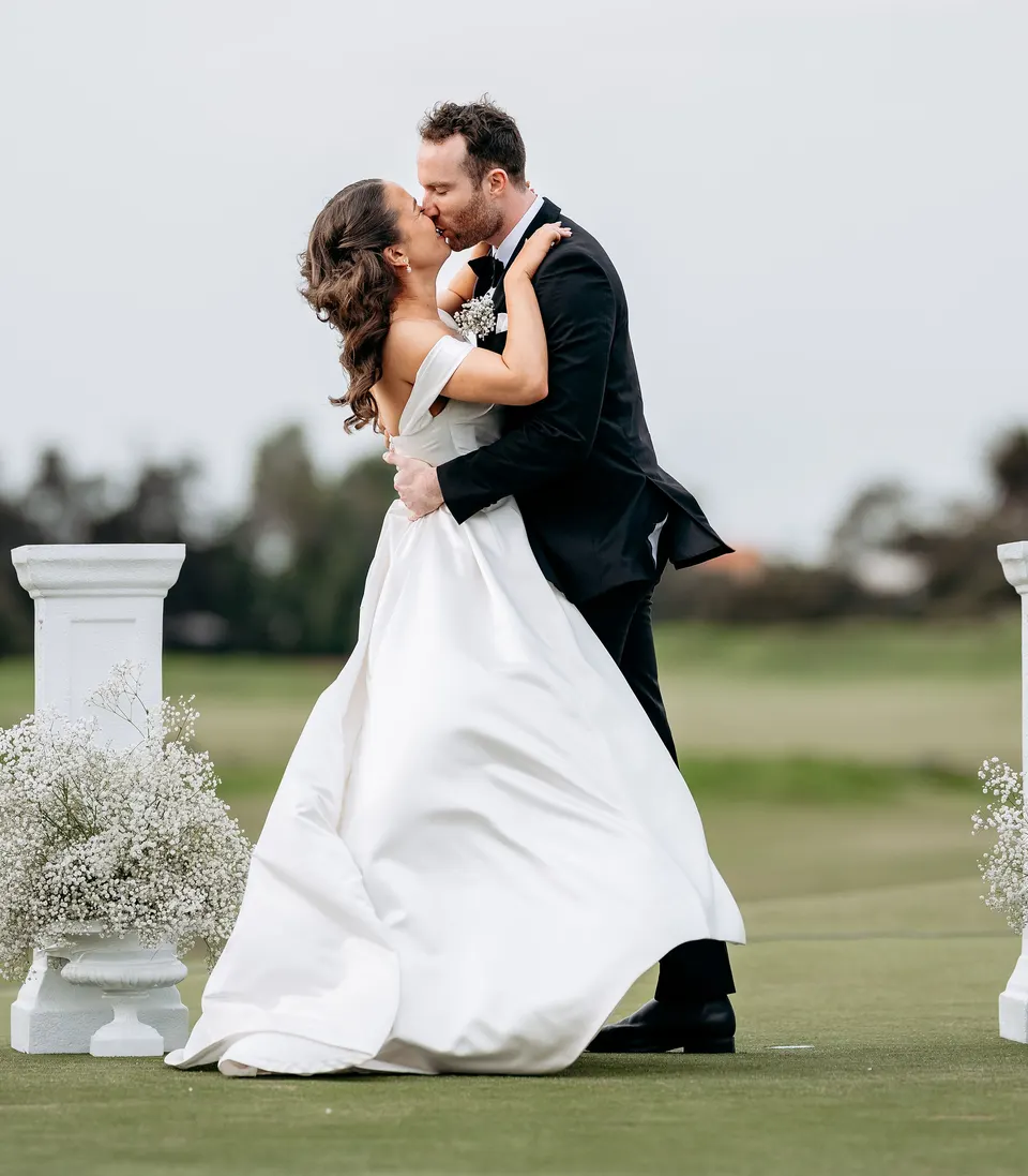 Henry and Elise's first kiss as a married couple, between the ceremony's white pillars